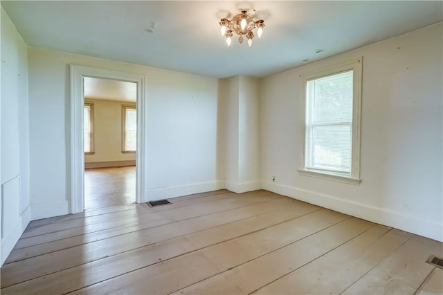 1621 Bragg St, Lima, NY 14485 - empty room featuring wood-type flooring, plenty of natural light, and a chandelier
