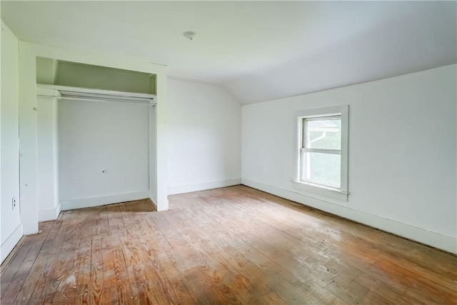 1621 Bragg St, Lima, NY 14485 - unfurnished bedroom with lofted ceiling, wood-type flooring, and a closet