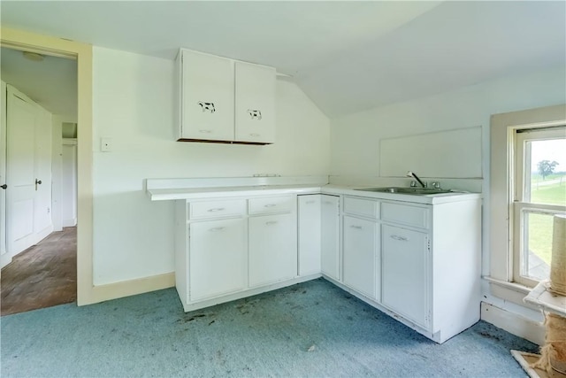 1621 Bragg St, Lima, NY 14485 - kitchen featuring white cabinetry, light countertops, lofted ceiling, and light colored carpet