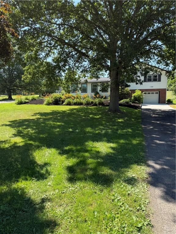 11948 River Rd, Corning, NY 14830 - view of front facade with an attached garage, asphalt driveway, and a front lawn