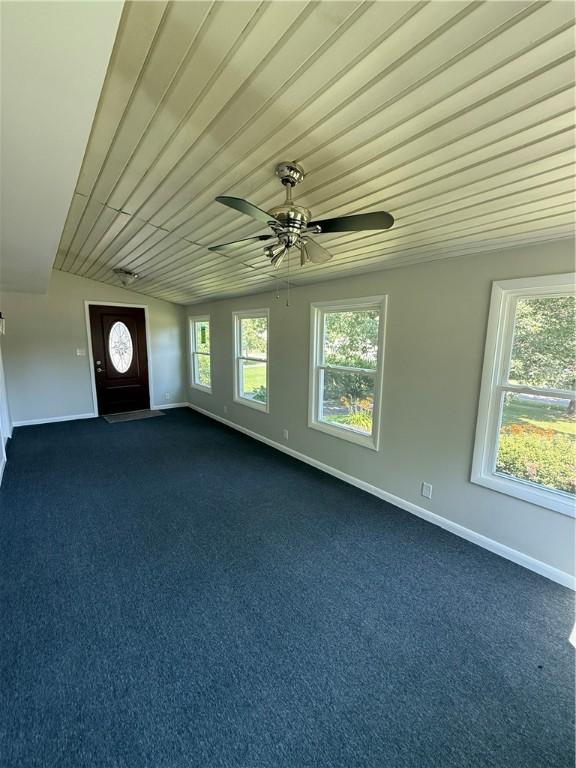 11948 River Rd, Corning, NY 14830 - empty room with dark carpet, a ceiling fan, and wooden ceiling