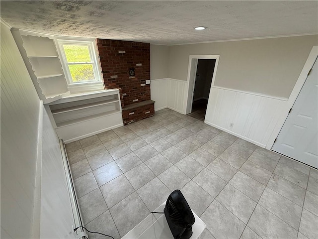 11948 River Rd, Corning, NY 14830 - unfurnished bedroom featuring light tile patterned floors, wainscoting, and a textured ceiling