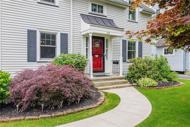 189 Hoover Rd, Irondequoit, NY 14617 - property entrance with a standing seam roof, a lawn, and a metal roof