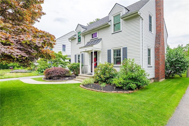 189 Hoover Rd, Irondequoit, NY 14617 - view of front facade with a front yard and a chimney