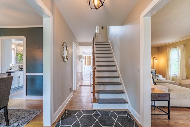 189 Hoover Rd, Irondequoit, NY 14617 - stairs with wood finished floors and crown molding