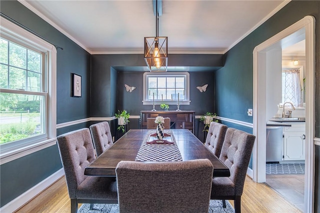 189 Hoover Rd, Irondequoit, NY 14617 - dining room featuring light wood-type flooring and ornamental molding