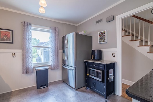 189 Hoover Rd, Irondequoit, NY 14617 - kitchen featuring appliances with stainless steel finishes, ornamental molding, blue cabinets, and dark stone counters