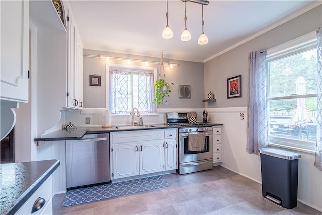 189 Hoover Rd, Irondequoit, NY 14617 - kitchen with appliances with stainless steel finishes, dark countertops, white cabinets, pendant lighting, and crown molding