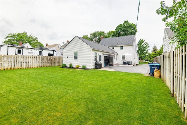 189 Hoover Rd, Irondequoit, NY 14617 - back of property featuring a fenced backyard, a garage, and a patio