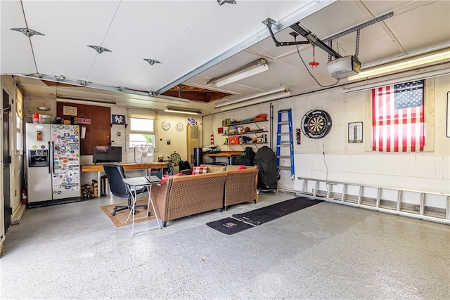 189 Hoover Rd, Irondequoit, NY 14617 - garage featuring stainless steel refrigerator with ice dispenser and a garage door opener