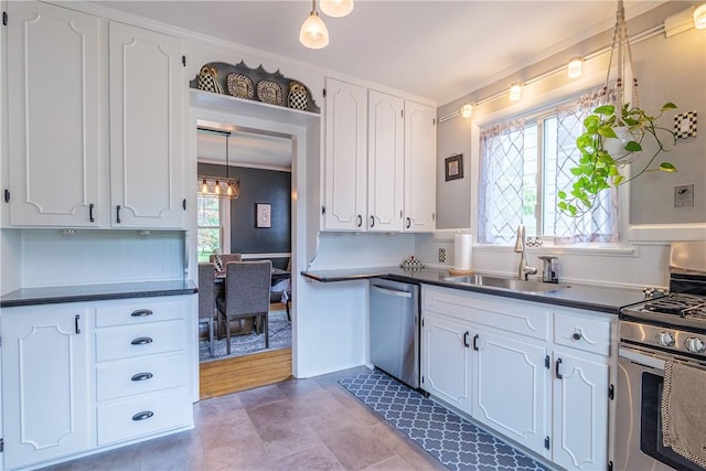 189 Hoover Rd, Irondequoit, NY 14617 - kitchen with stainless steel appliances, dark countertops, white cabinetry, crown molding, and pendant lighting