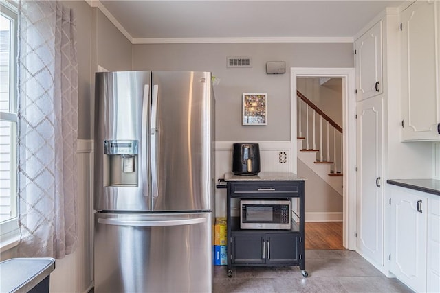 189 Hoover Rd, Irondequoit, NY 14617 - kitchen with appliances with stainless steel finishes, white cabinets, ornamental molding, and light tile patterned flooring