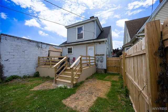 2906 Pine Ave, Niagara Falls, NY 14301 - back of house with a chimney, a fenced backyard, a deck, and a shingled roof
