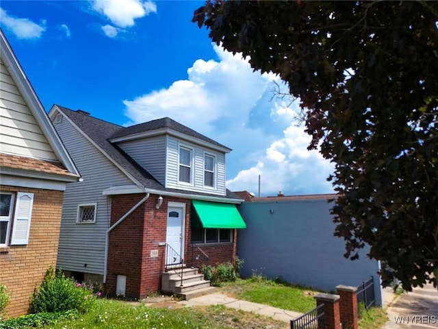 2906 Pine Ave, Niagara Falls, NY 14301 - bungalow-style home with brick siding, entry steps, and a shingled roof