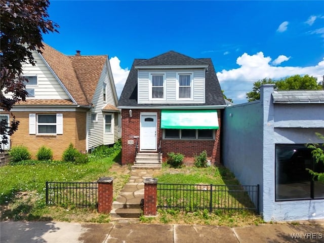2906 Pine Ave, Niagara Falls, NY 14301 - bungalow-style home featuring brick siding, a fenced front yard, entry steps, and a shingled roof