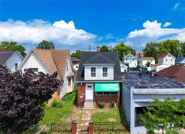 2906 Pine Ave, Niagara Falls, NY 14301 - view of front of property featuring entry steps, a fenced front yard, brick siding, a residential view, and a shingled roof