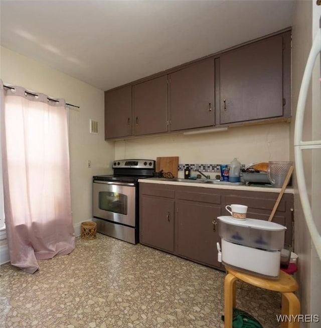 2906 Pine Ave, Niagara Falls, NY 14301 - kitchen featuring stainless steel electric range, light countertops, and freestanding refrigerator