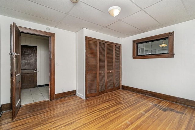 1570 Mount Hope Ave, Rochester, NY 14620 - unfurnished bedroom with light wood-style flooring, a closet, and a drop ceiling
