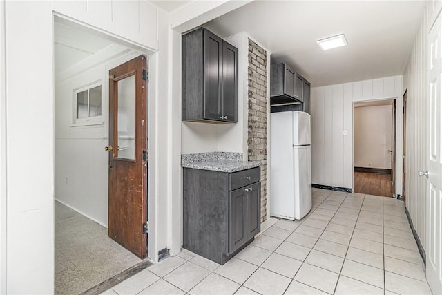 1570 Mount Hope Ave, Rochester, NY 14620 - kitchen with freestanding refrigerator, light tile patterned floors, and light stone countertops