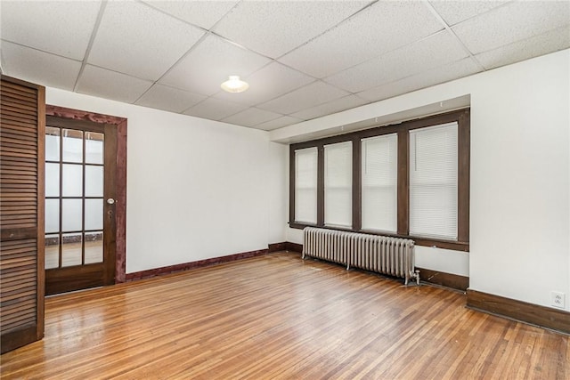 1570 Mount Hope Ave, Rochester, NY 14620 - spare room with radiator heating unit, wood finished floors, and a paneled ceiling