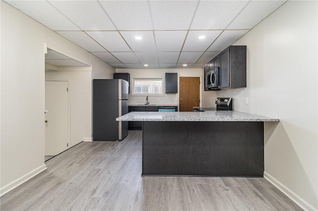 1570 Mount Hope Ave, Rochester, NY 14620 - kitchen featuring appliances with stainless steel finishes, a peninsula, light wood finished floors, recessed lighting, and a drop ceiling