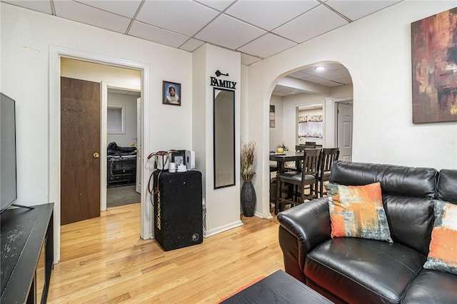 1570 Mount Hope Ave, Rochester, NY 14620 - living area featuring arched walkways, a paneled ceiling, and light wood-style flooring