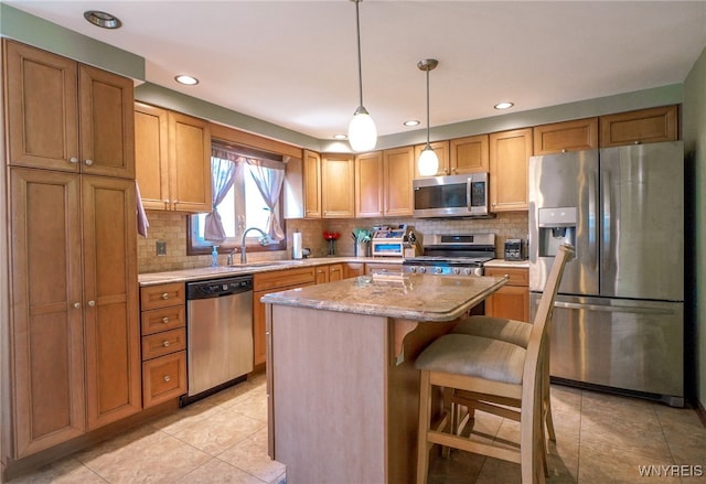 117 Colony St, Lancaster, NY 14043 - kitchen with appliances with stainless steel finishes, a kitchen island, tasteful backsplash, light tile patterned flooring, and recessed lighting