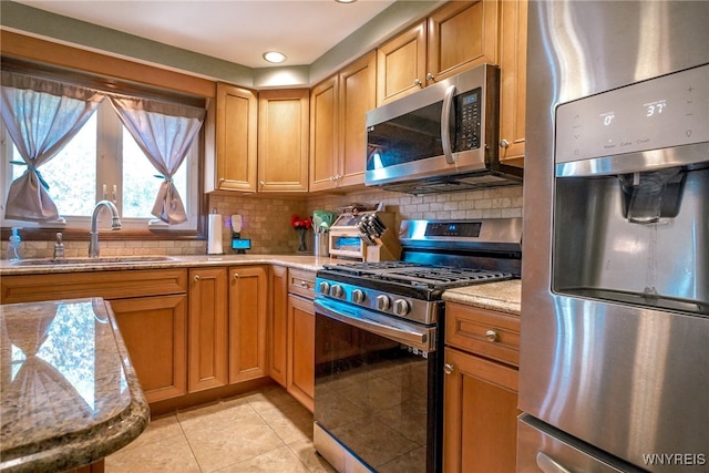 117 Colony St, Lancaster, NY 14043 - kitchen with appliances with stainless steel finishes, light tile patterned floors, light stone counters, backsplash, and recessed lighting