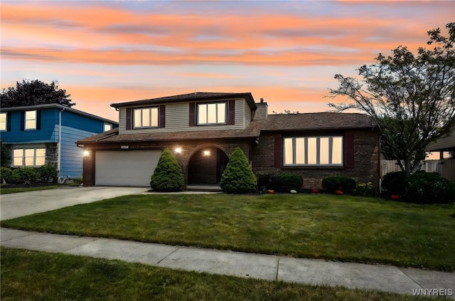 117 Colony St, Lancaster, NY 14043 - view of front of house with driveway, an attached garage, a chimney, and brick siding