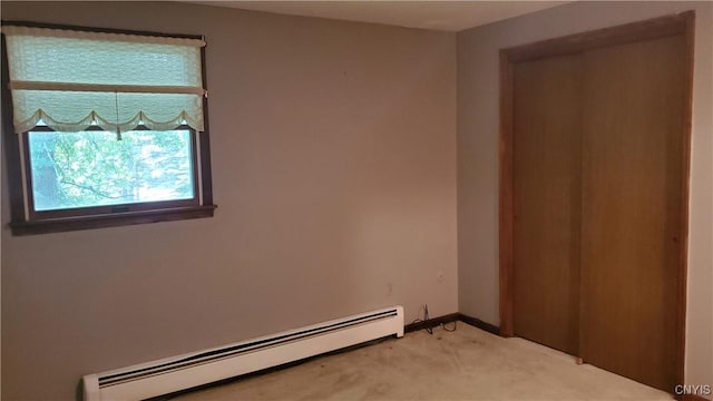 582 Peck Rd, Sullivan, NY 13082 - unfurnished bedroom with a baseboard radiator and light colored carpet