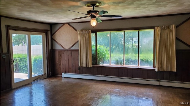 582 Peck Rd, Sullivan, NY 13082 - spare room with a baseboard radiator, ceiling fan, crown molding, and wood walls