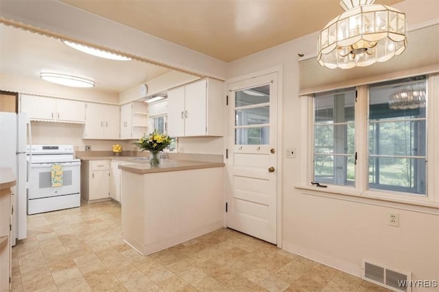 356 Union Rd, West Seneca, NY 14224 - kitchen with electric range, a peninsula, white cabinets, and open shelves