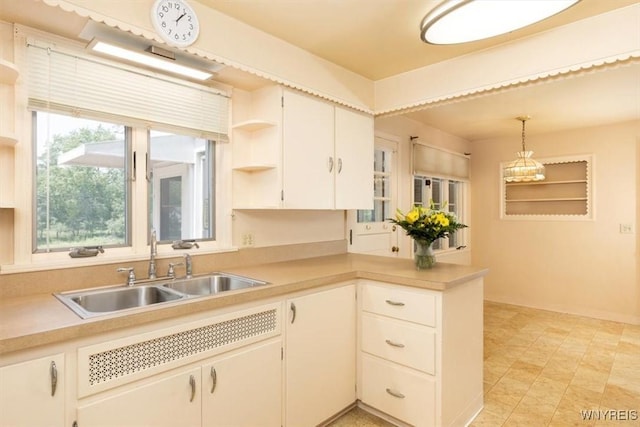 356 Union Rd, West Seneca, NY 14224 - kitchen with light countertops, a peninsula, open shelves, and hanging light fixtures