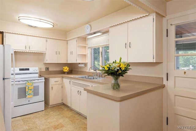 356 Union Rd, West Seneca, NY 14224 - kitchen featuring white appliances, light countertops, open shelves, and a peninsula