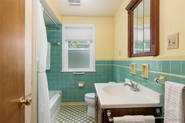 356 Union Rd, West Seneca, NY 14224 - full bath featuring tile walls, vanity, a wainscoted wall, shower / tub combo with curtain, and tile patterned floors