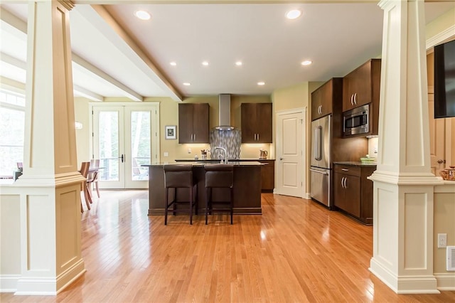 1537 Cranberry Pond, Victor, NY 14564 - kitchen featuring ornate columns, stainless steel appliances, wall chimney range hood, light wood-style flooring, and recessed lighting