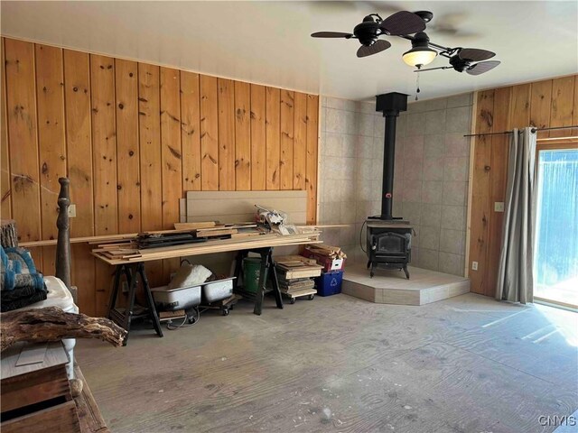 108 Linlyco Lake Rd, New Albion, NY 14719 - home office with a wood stove, plenty of natural light, a ceiling fan, and wooden walls