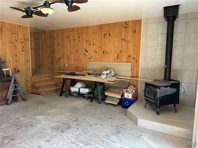 108 Linlyco Lake Rd, New Albion, NY 14719 - basement with a wood stove, ceiling fan, and wood walls