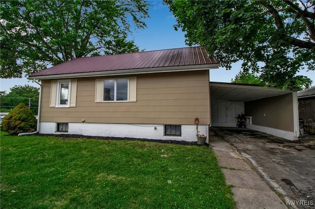201 Ohio St, Ridgeway, NY 14103 - view of side of home featuring asphalt driveway, a lawn, and a metal roof