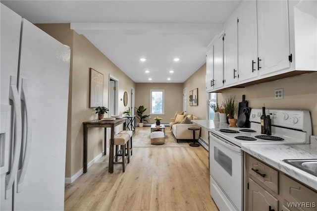 201 Ohio St, Ridgeway, NY 14103 - kitchen with white appliances, light wood finished floors, white cabinets, recessed lighting, and open floor plan