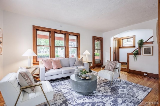 72 Manchester St, Rochester, NY 14621 - living area featuring wood finished floors, a textured ceiling, and arched walkways