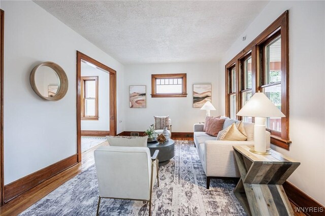 72 Manchester St, Rochester, NY 14621 - living room with wood finished floors and a textured ceiling