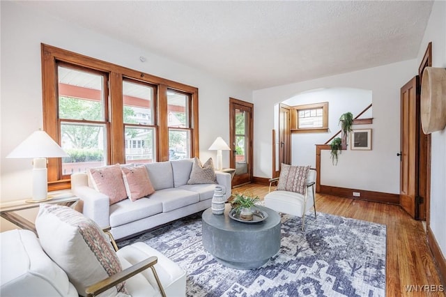 72 Manchester St, Rochester, NY 14621 - living room featuring wood finished floors, arched walkways, and a textured ceiling