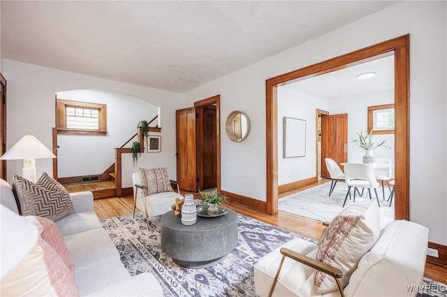 72 Manchester St, Rochester, NY 14621 - living area with stairway, light wood finished floors, arched walkways, and plenty of natural light