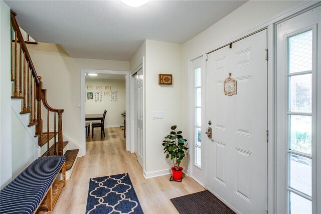 47 Stonington Dr, Pittsford, NY 14534 - foyer with light wood-style flooring, stairway, and healthy amount of natural light