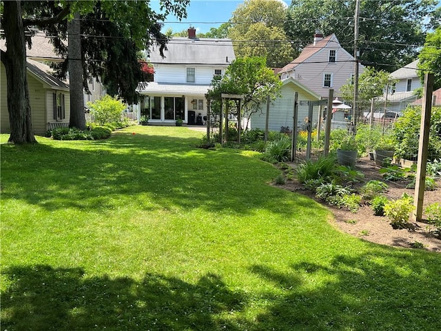 78 Falleson Rd, Rochester, NY 14612 - view of green lawn with a vegetable garden
