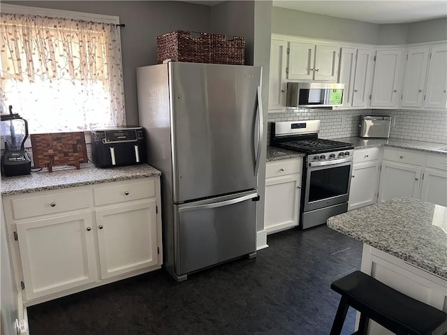 78 Falleson Rd, Rochester, NY 14612 - kitchen featuring appliances with stainless steel finishes, decorative backsplash, white cabinetry, and light stone counters