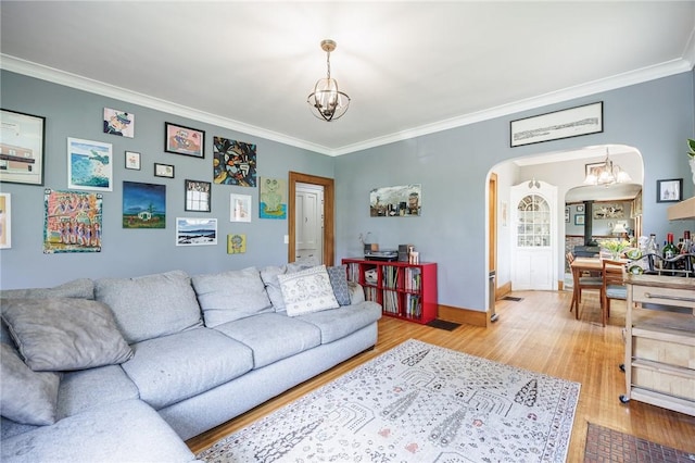 142 Holloway Rd, Brighton, NY 14610 - living area featuring arched walkways, a chandelier, crown molding, and light wood-type flooring