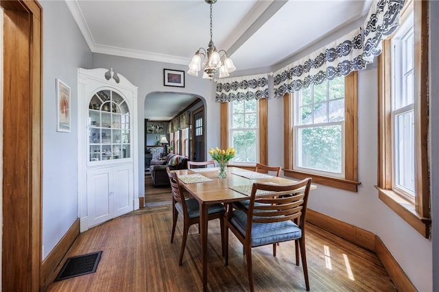 142 Holloway Rd, Brighton, NY 14610 - dining space featuring arched walkways, wood finished floors, and a chandelier