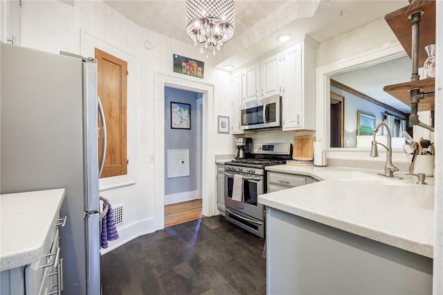 142 Holloway Rd, Brighton, NY 14610 - kitchen with stainless steel appliances, light countertops, a chandelier, white cabinets, and dark wood-style floors